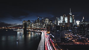 New York City Manhattan Skyline at Night with Brooklyn Bridge and Long Exposure Traffic Trails HD wallpaper