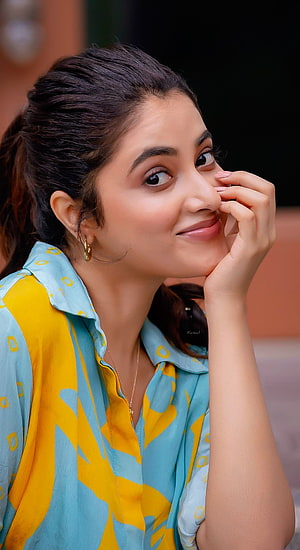 Priyanka Mohan in a colorful blue and yellow patterned blouse with a warm smile HD phone wallpaper