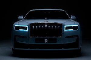 Rolls Royce Ghost Front Facade With Illuminated Headlights In Dark Studio Setting HD wallpaper