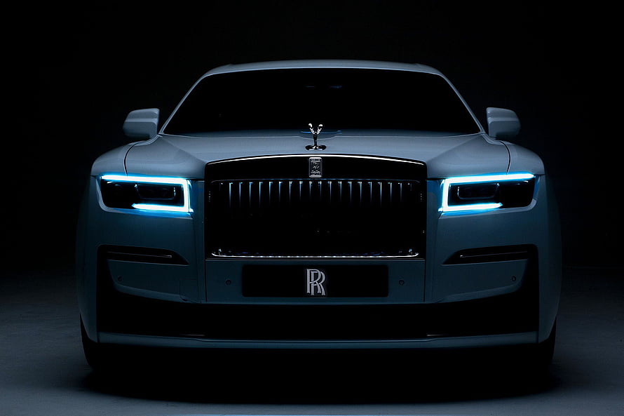 Rolls Royce Ghost Front Facade With Illuminated Headlights In Dark Studio Setting HD wallpaper