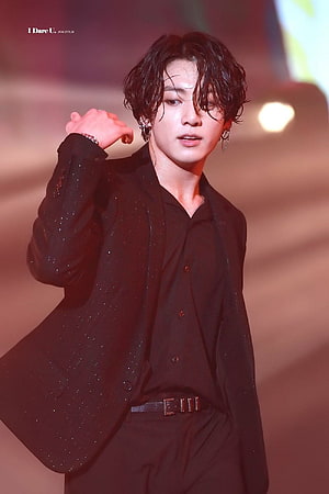 Jungkook BTS performing on stage in a sparkling black suit with wavy hair and earrings HD phone wallpaper