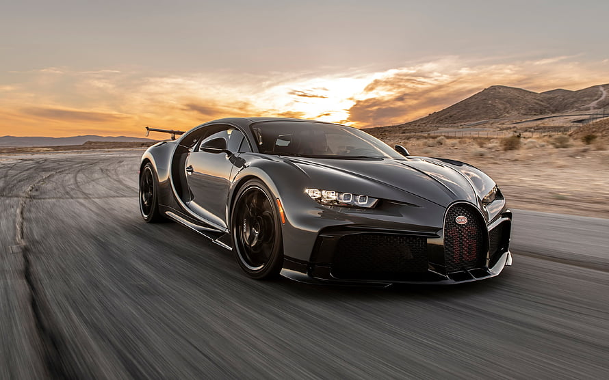Black Bugatti Chiron Pur Sport Hypercar Driving on Desert Road at Sunset HD wallpaper