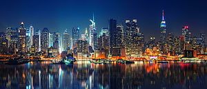 New York City Skyline at Night with Empire State Building and Water Reflections HD wallpaper