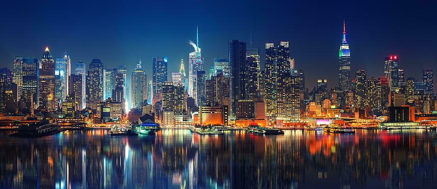 New York City Skyline at Night with Empire State Building and Water Reflections HD wallpaper