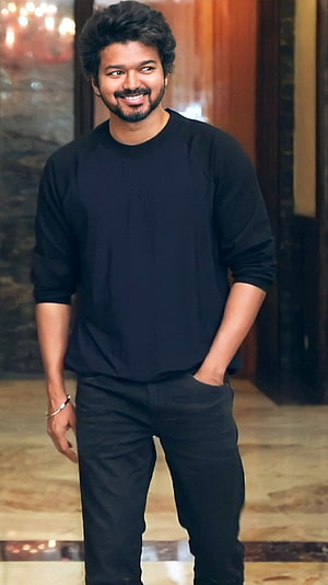Vishal standing in a black outfit with a confident smile HD phone wallpaper