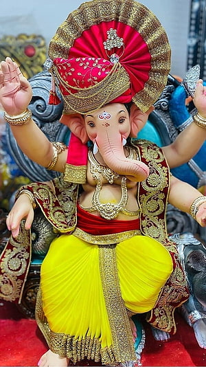 Ganesh Chaturthi Idol of Lord Ganesha in Red and Yellow Attire HD phone wallpaper