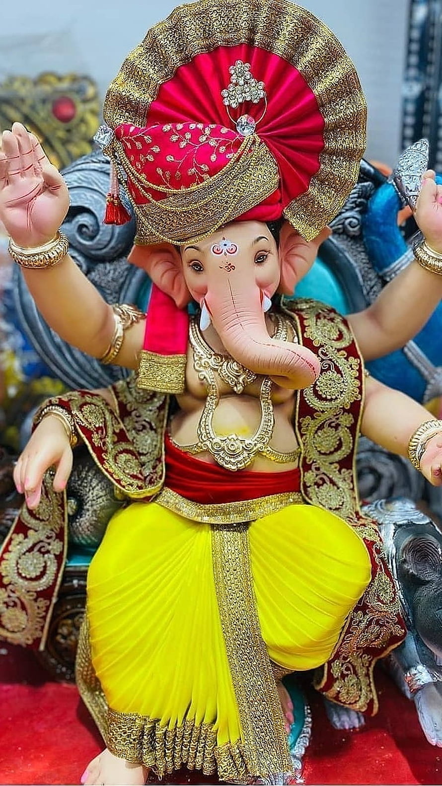 Ganesh Chaturthi Idol of Lord Ganesha in Red and Yellow Attire HD phone wallpaper