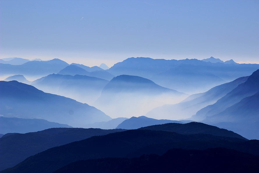 Layered Mountain Ranges Shrouded in Soft Morning Mist and Haze HD wallpaper