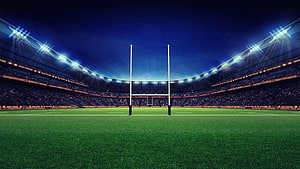 Illuminated Rugby Stadium at Night with Goal Posts and Floodlights HD wallpaper