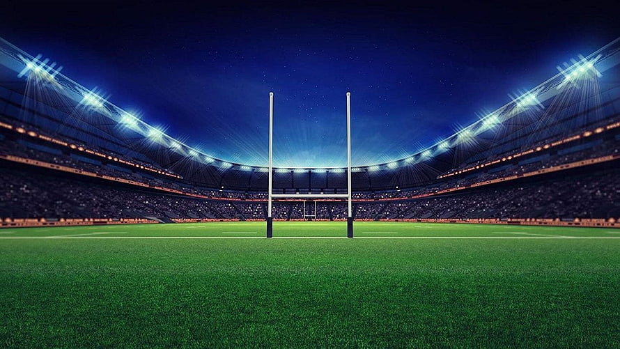Illuminated Rugby Stadium at Night with Goal Posts and Floodlights HD wallpaper