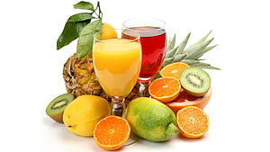 Fresh Tropical Fruit Arrangement With Pineapple, Kiwi, Oranges, Lemon, Lime, And Two Glasses Of Juice HD wallpaper