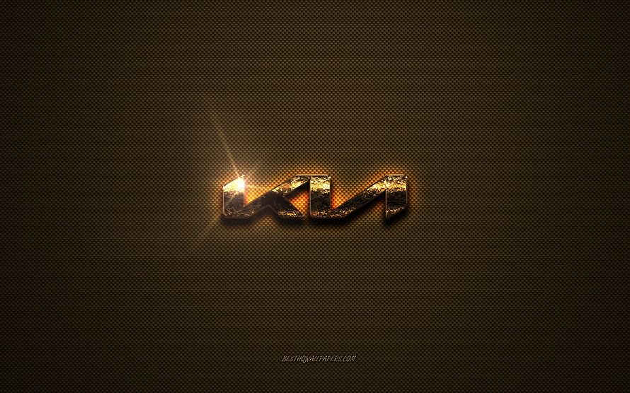 Kia Golden Emblem on Textured Brown Metal Background with Dramatic Lighting HD wallpaper