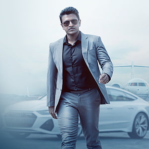 Stylish man in grey suit and sunglasses walking confidently with luxury car and private jet background, Puneeth Rajkumar, coat, suite, appu, class HD phone wallpaper