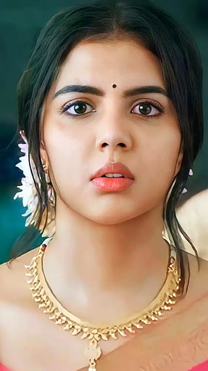 Kalyani Priyadarshini Portrait With Gold Necklace And Floral Hair Adornment HD phone wallpaper