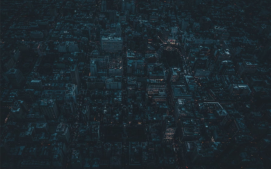 Aerial View of a Dark City at Night with Blue Tint and Scattered Lights HD wallpaper