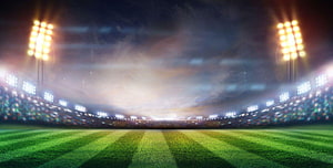 Empty Soccer Stadium at Night with Bright Floodlights and Green Grass Field HD wallpaper