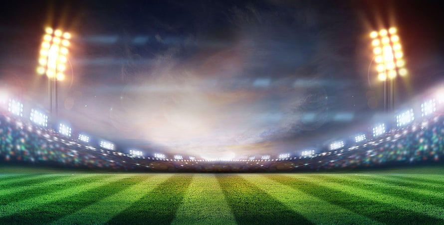 Empty Soccer Stadium at Night with Bright Floodlights and Green Grass Field HD wallpaper