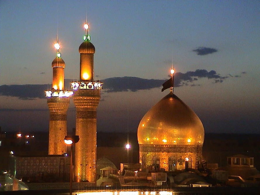 Karbala Shrine of Imam Hussain at Dusk with Illuminated Minarets and Golden Dome HD wallpaper
