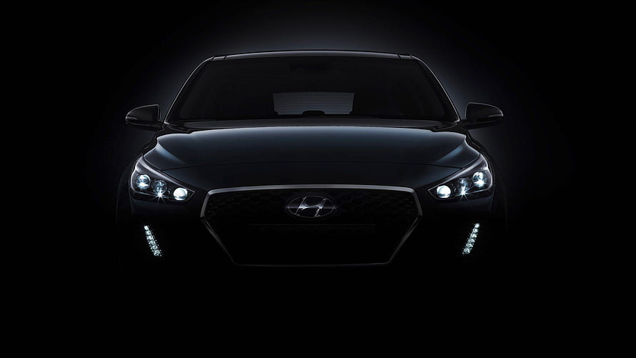 Front View of a Black Hyundai Sedan with Illuminated Headlights in Dark Atmosphere HD wallpaper