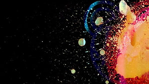 Vibrant Abstract Ink Splatter with Swirling Blue and Orange Hues on Black Background HD wallpaper