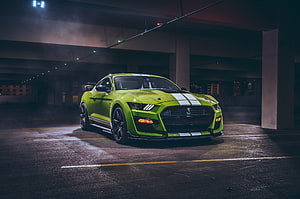 Lime Green Ford Mustang Shelby GT500 with Racing Stripes in a Dark Underground Parking Garage HD wallpaper