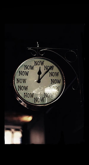 Vintage Wall Clock with Repeating Now Text in Dark Moody Setting HD phone wallpaper