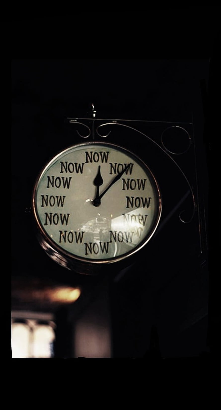 Vintage Wall Clock with Repeating Now Text in Dark Moody Setting HD phone wallpaper
