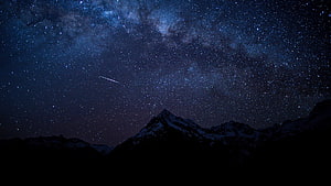 Milky Way Galaxy and Shooting Star Over Snow-Capped Mountain Peaks at Night HD wallpaper