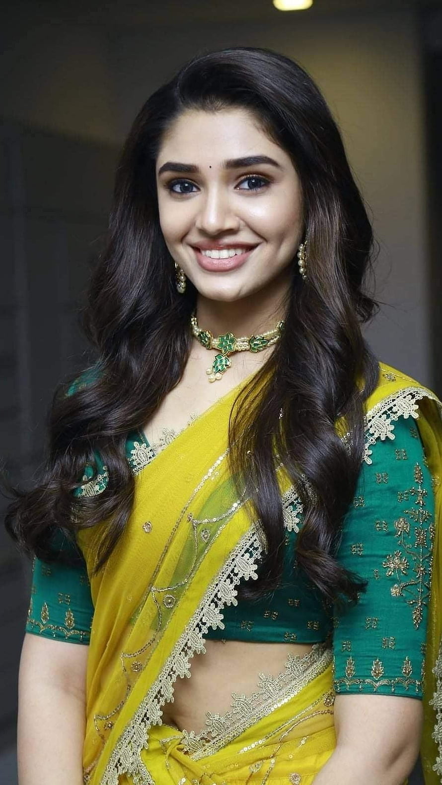 Bhavana Menon in a stunning yellow and green saree with gold embroidery and traditional jewelry HD phone wallpaper