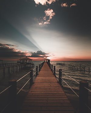 Serene Wooden Pier Extending Into Ocean At Sunset With Dramatic Clouds HD phone wallpaper