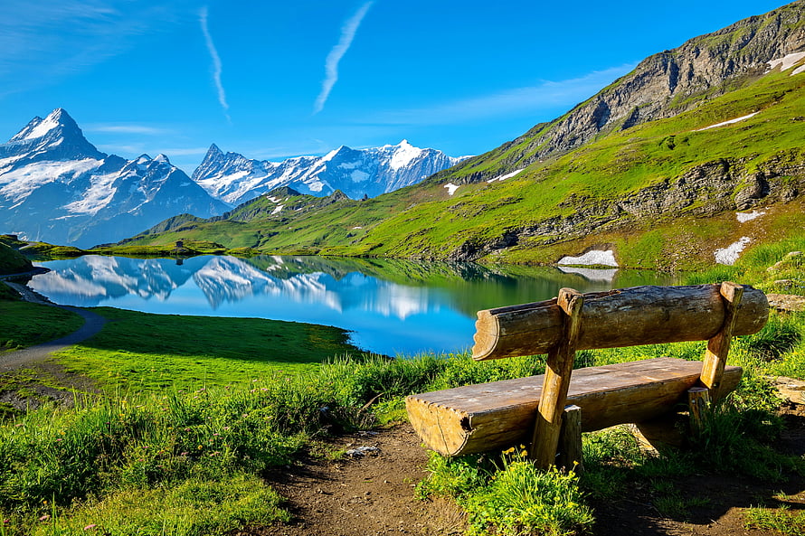 Scenic Alpine Lake with Wooden Bench and Snow-Capped Mountains HD wallpaper