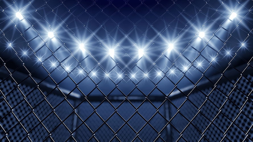 UFC Octagon Chain-Link Fence with Bright Stadium Lights at Night HD wallpaper