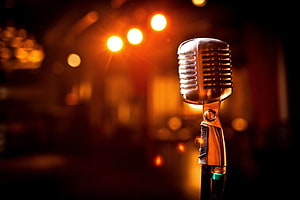 Vintage Retro Microphone on Stage with Warm Bokeh Lighting HD wallpaper