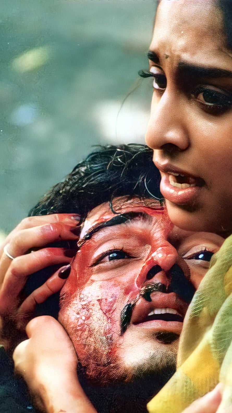 Emotional movie scene featuring a bloodied man being held by a distressed woman in a dramatic close-up, Amarkalam, tamil movie, ajith kumar, shalini HD phone wallpaper