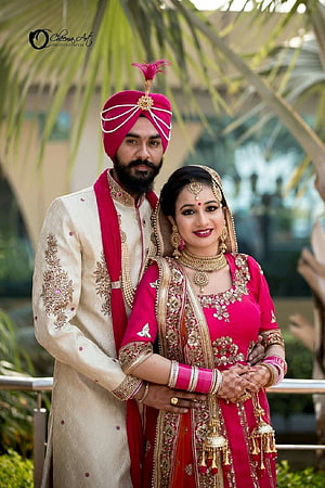 Elegant Indian Wedding Couple in Traditional Attire with Gold Jewelry and Turban HD phone wallpaper