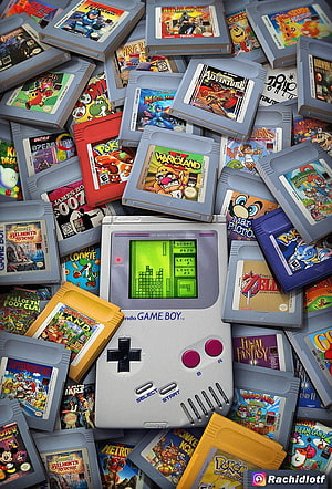 Classic Nintendo Game Boy Console Surrounded by Retro Game Cartridges HD phone wallpaper