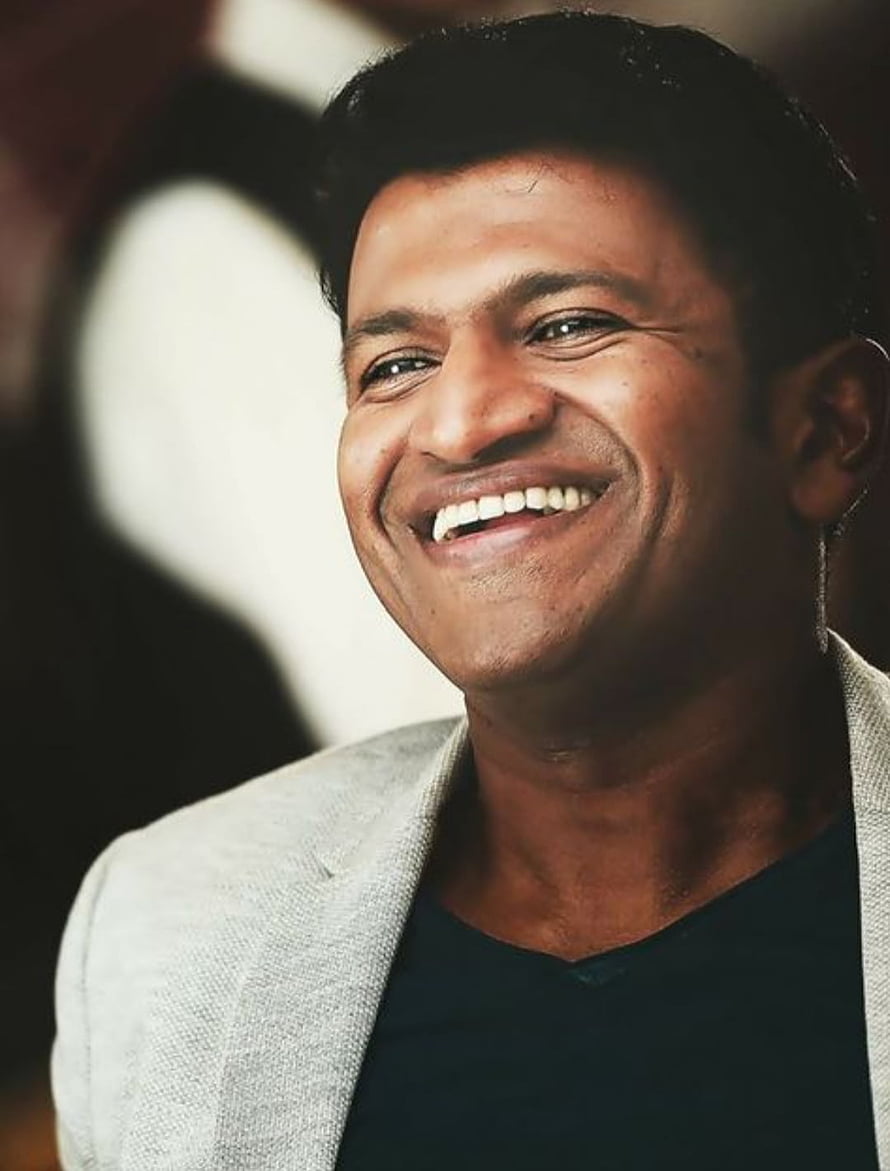 Puneeth Rajkumar Smiling Portrait in Light Grey Blazer and Black Shirt HD phone wallpaper
