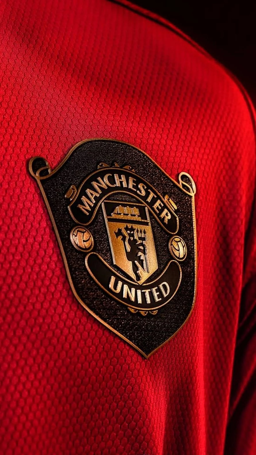 Manchester United Crest Close-Up on Red Jersey Fabric HD phone wallpaper