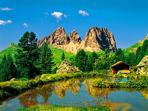 Alpine Mountain Peaks Reflected in a Serene Forest Pond with a Red Cabin HD wallpaper