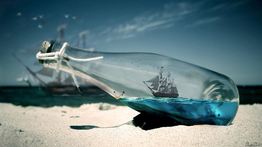 Pirates of the Caribbean ship sailing inside a glass bottle on a sandy beach HD wallpaper
