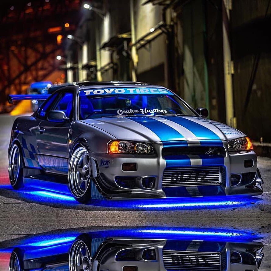 Silver and Blue Nissan Skyline GT-R R34 with Underglow at Night HD phone wallpaper