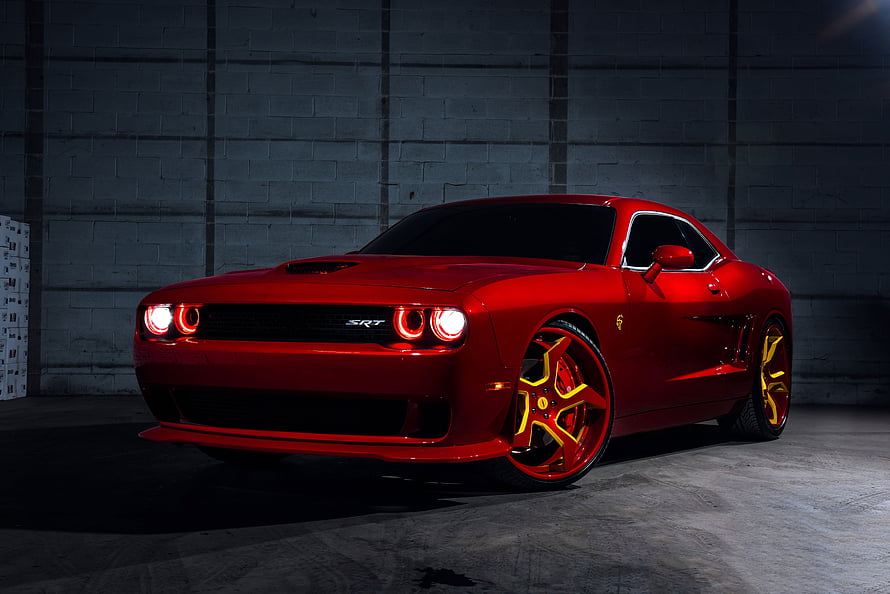 Red Dodge Challenger SRT Hellcat with Custom Yellow Rims in a Dark Garage HD wallpaper
