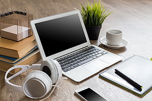 Modern Workspace Setup With Laptop, Headphones, Coffee, And Desk Accessories HD wallpaper