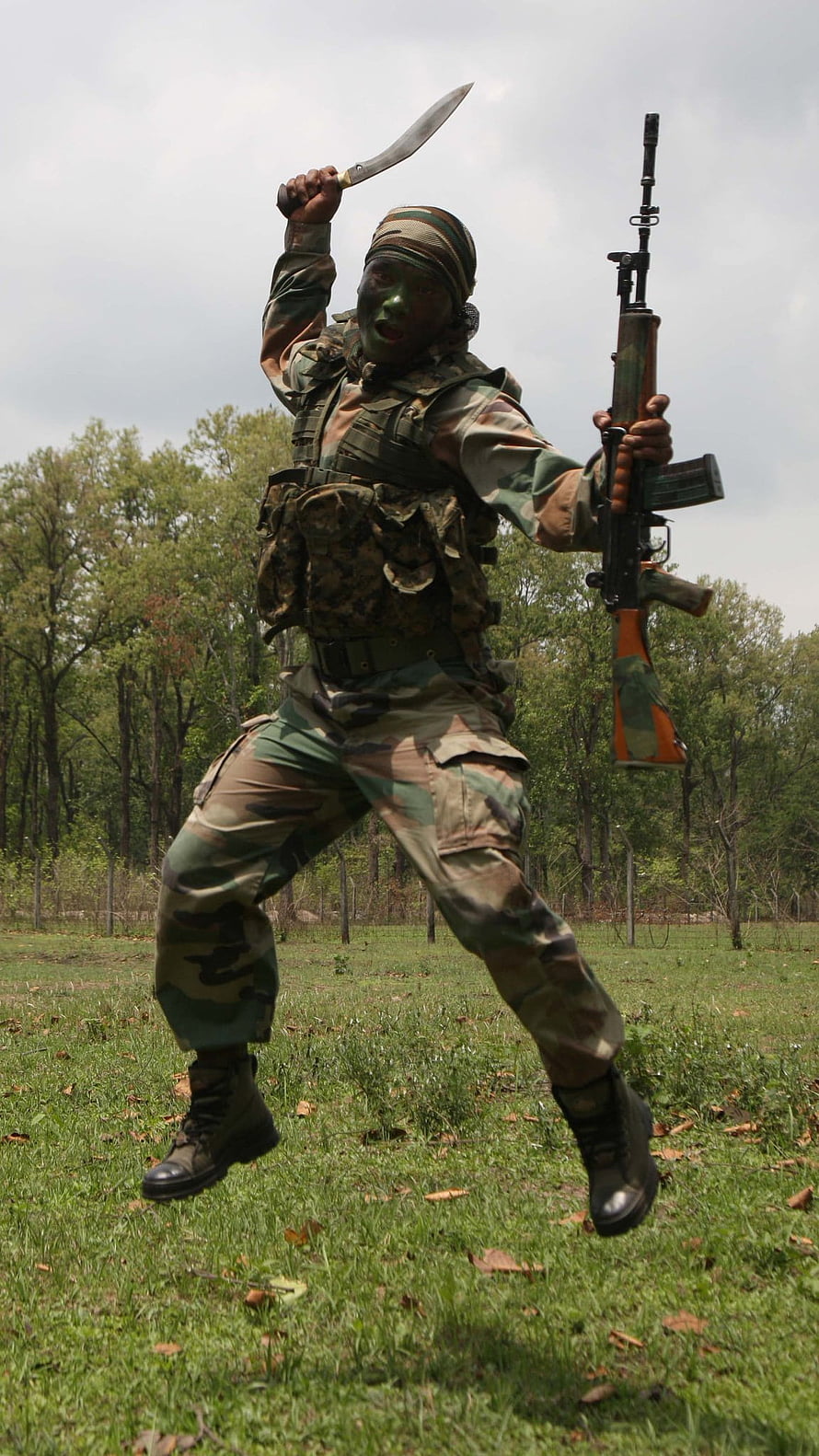 Indian Army Gorkha Soldier in Camouflage Holding Kukri and Rifle in a Forest Clearing HD phone wallpaper