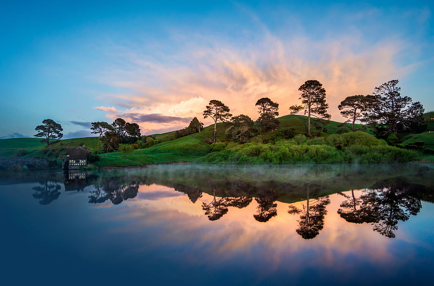 The Shire Hobbiton Movie Set at Sunset with Lake Reflection HD wallpaper