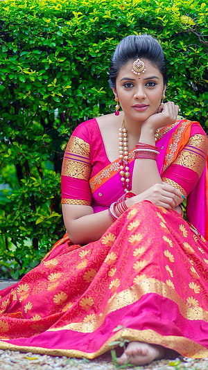 Sreemukhi in a vibrant pink and gold traditional saree with elegant jewelry HD phone wallpaper