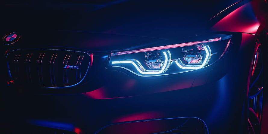 BMW M4 Front Headlight Detail with Neon Blue and Red Lighting HD wallpaper