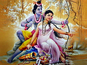Radha and Krishna sitting together in a forest with a bow, flute, and deer HD wallpaper