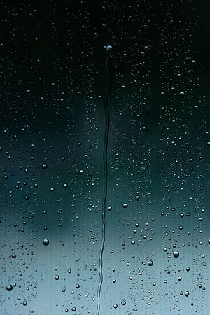 Rain Droplets on Glass Window with Vertical Water Streak Against Moody Teal Background HD phone wallpaper
