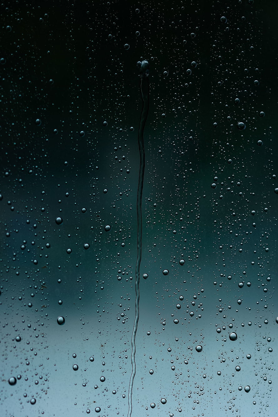 Rain Droplets on Glass Window with Vertical Water Streak Against Moody Teal Background HD phone wallpaper